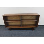 A set of mid century teak sliding glass door bookshelves