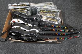 A box of four guitar hero guitars,