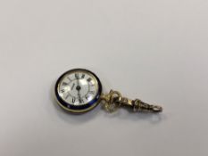 An enamelled fob watch upon a gold catch