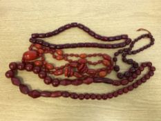 Four cherry amber style bead necklaces CONDITION REPORT: Untested.