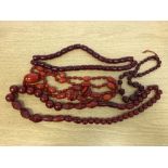 Four cherry amber style bead necklaces CONDITION REPORT: Untested.