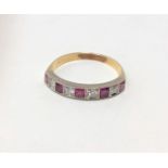 An 18ct gold ruby and diamond half eternity ring,