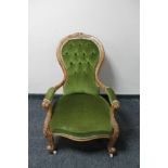 A Victorian carved oak framed gentleman's armchair in green dralon