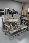 A set of four teak hardwood garden armchairs together with a folding teak occasional table