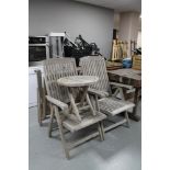 A set of four teak hardwood garden armchairs together with a folding teak occasional table