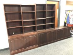 Two sets of open bookshelves and a double door cupboard