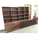 Two sets of open bookshelves and a double door cupboard