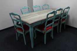 A French farmhouse kitchen table on painted base together with a set of seven painted ladder backed