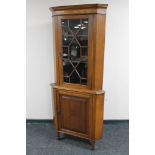 An Edwardian oak astragal glazed corner cabinet