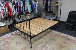 A Victorian cast iron and brass 4'6" bed frame