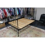 A Victorian cast iron and brass 4'6" bed frame