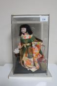 A 20th Century doll - Dancing Geisha in Full Costume, on fixed base, in perspex display cabinet,