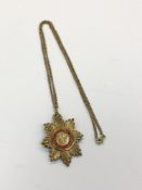 A silver gilt OBE pendant on chain