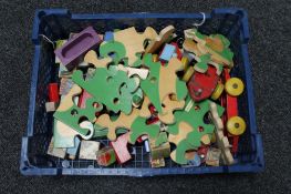 A box of early 20th century wooden jigsaw and toys