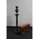 A narrow drop leaf table together with a carved wooden vase on stand
