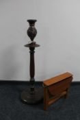 A narrow drop leaf table together with a carved wooden vase on stand