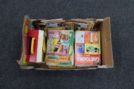 A box of Fisher Price music box record player together with a quantity of comics, cartoon books,