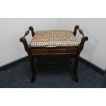 An Edwardian storage piano stool