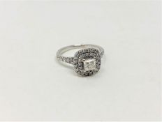 An 18ct white gold diamond cluster ring, the central princess cut stone of 0.