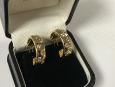 A pair of 18ct gold diamond set earrings, approximately 1.