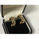 A pair of 18ct gold diamond set earrings, approximately 1.