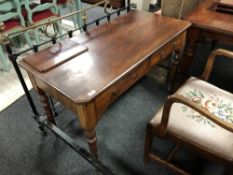 A Victorian mahogany two drawer side table on reeded legs