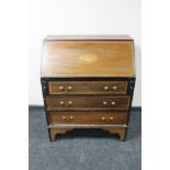 A Victorian inlaid mahogany writing bureau fitted with three drawers