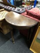 A Victorian D-shaped turnover top table on club feet