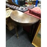 A Victorian D-shaped turnover top table on club feet