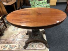 A 19th century continental mahogany pedestal table on paw feet