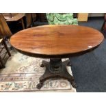 A 19th century continental mahogany pedestal table on paw feet