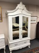 A contemporary white double mirrored wardrobe, fitted with a drawer, width 116 cm.