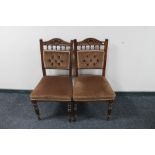A pair of carved Edwardian dining chairs in brown dralon
