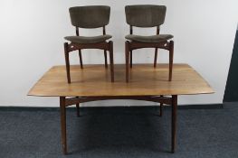 A mid century Dalescraft rectangular teak dining table and two teak chairs