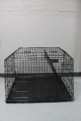 A folding metal dog cage,