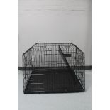 A folding metal dog cage,