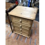 A pine four drawer bedside chest