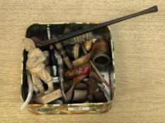 A tin of antique pipes, Black Forest style carved figure,