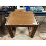 A nest of three mid century teak tables