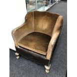 An Art Deco low backed armchair in brown dralon