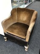 An Art Deco low backed armchair in brown dralon