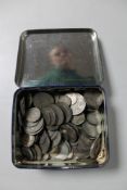 A tin of mid 20th century British coins, silver half crowns,