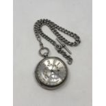 A large antique silver pocket watch with silver dial on heavy antique silver Albert chain