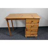 A pine kneehole desk fitted with four drawers