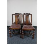 A set of four carved Edwardian oak dining chairs