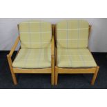 A mid century beech framed Ercol armchair together with one other chair