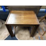 A nest of three mid century teak tables