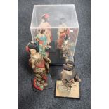 A perspex display case together with six Geisha figures