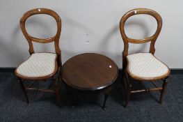 A pair of antique balloon backed bedroom chairs together with a circular mahogany coffee table