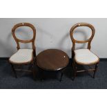 A pair of antique balloon backed bedroom chairs together with a circular mahogany coffee table